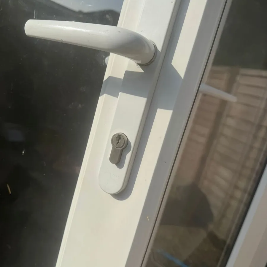 A new euro cylinder fitted in a white uPVC back door