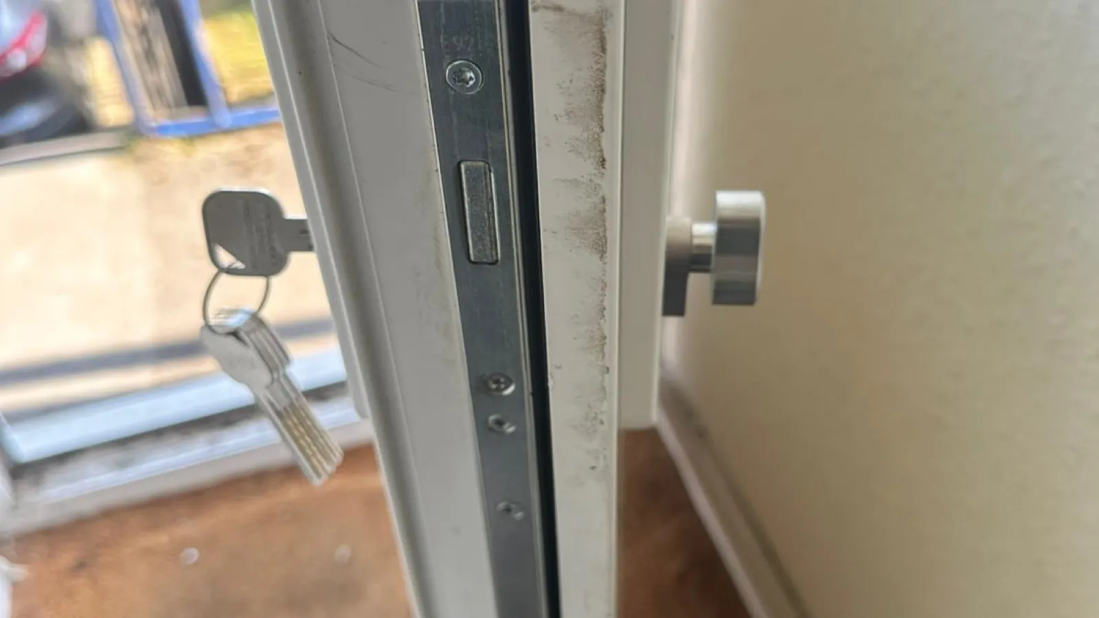 A uPVC door edge with the multipoint mechanism serviced and new keys ready for handover