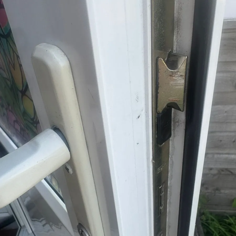A uPVC frame keep adjusted so the new lock throws smoothly